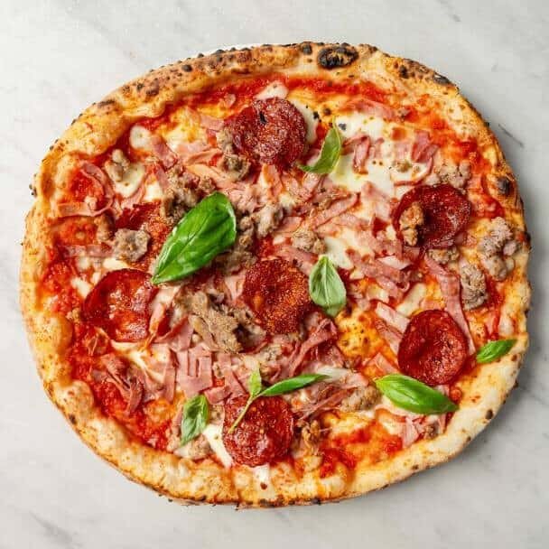 4 Salumi pizza topped with fior di latte, San Marzano tomato, ham, Italian pork sausage, mild salami, and hot salami