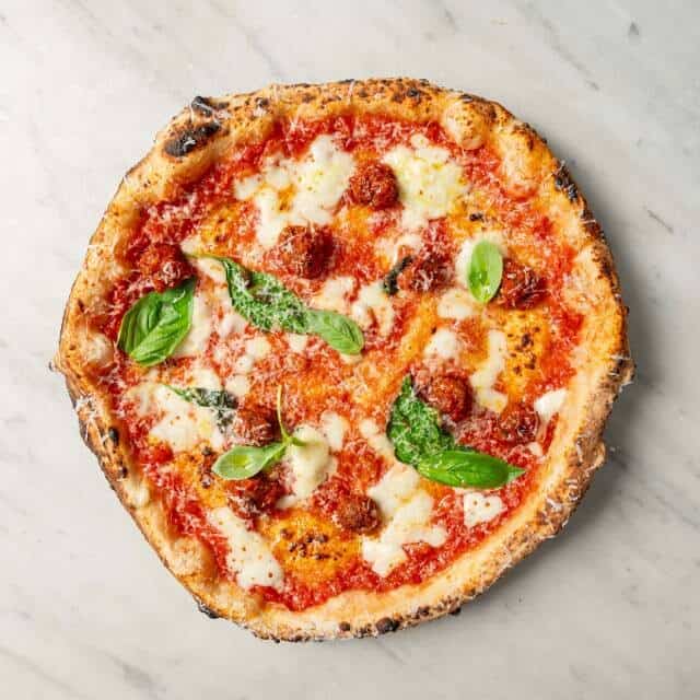 Allegra pizza topped with fior di latte, San Marzano tomato, Nonna Giuseppina’s wagyu meatballs, Pecorino Romano, black pepper, and fresh basil