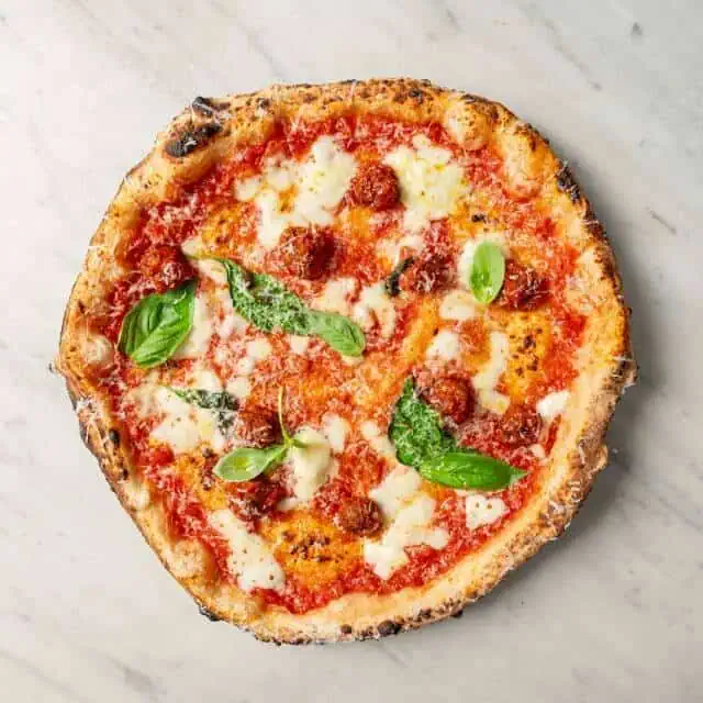 Allegra pizza topped with fior di latte, San Marzano tomato, Nonna Giuseppina’s wagyu meatballs, Pecorino Romano, black pepper, and fresh basil