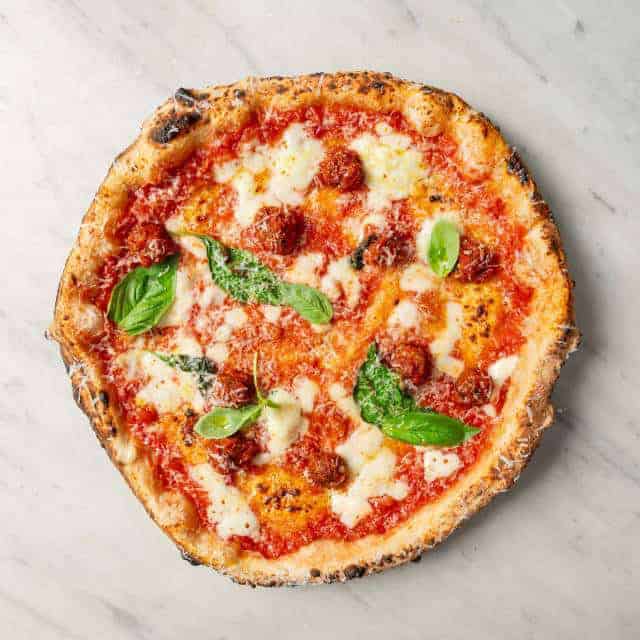 Allegra pizza topped with Solania San Marzano tomatoes, Fior di Latte, Nonna Giuseppina’s beef meatballs, Pecorino Romano, black pepper, basil, and EVOO at Via Napol