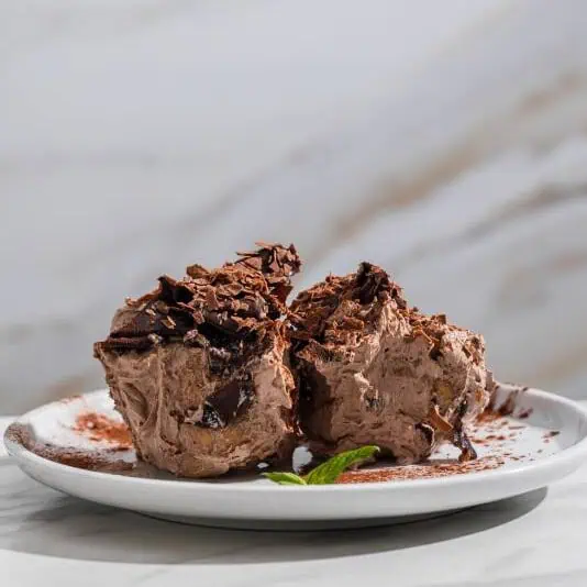 Italian chocolate profiteroles filled with cream and coated in rich chocolate sauce