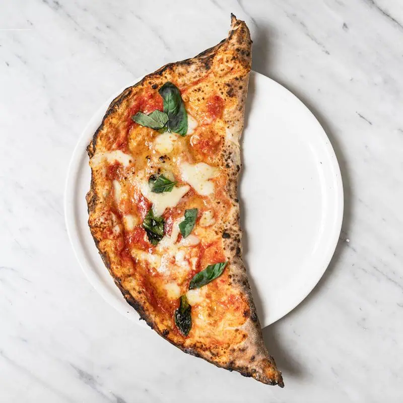 Calzone con cotto filled with fior di latte, San Marzano tomato, double smoked shoulder ham, ricotta, parmesan, pepper, and fresh basil