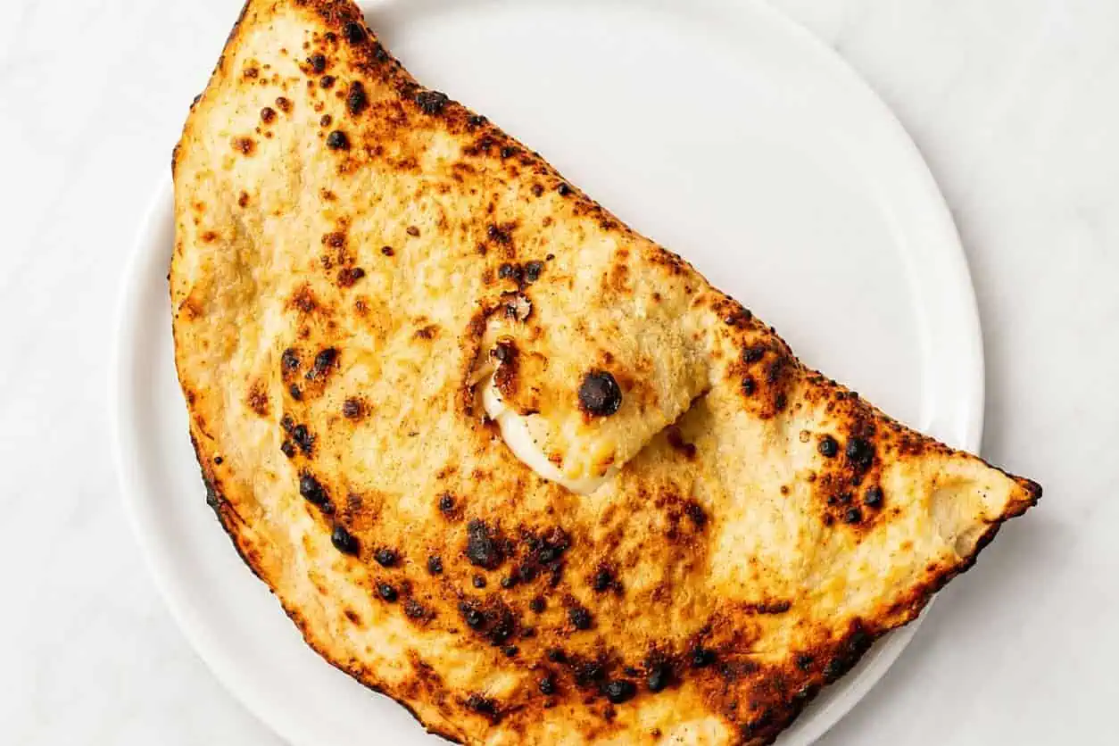 Calzone - Folded Pizza, Solania San Marzano, Fior di Latte, Buffalo Ricotta, Pepper, Basil, EVOO. Choice of Double Smoked Shoulder Ham or Mild Neapolitan Salami