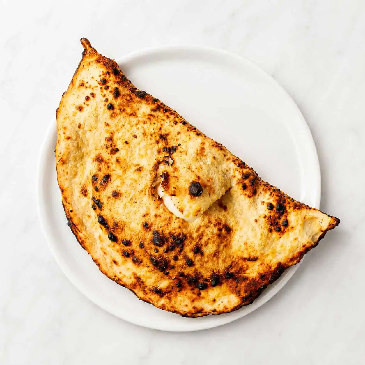 Calzone - Folded Pizza, Solania San Marzano, Fior di Latte, Buffalo Ricotta, Pepper, Basil, EVOO. Choice of Double Smoked Shoulder Ham or Mild Neapolitan Salami