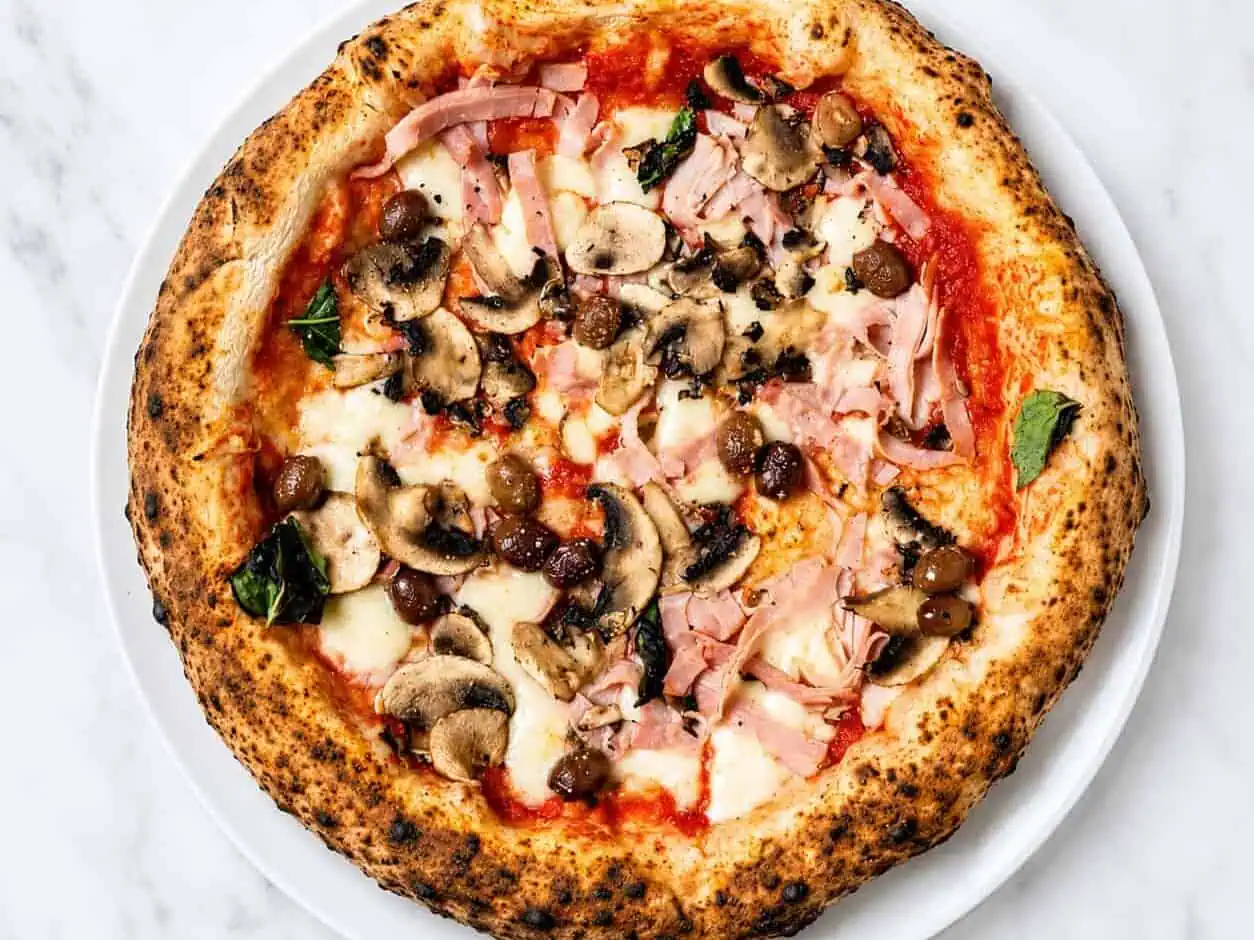 Capricciosa Pizza - Solania San Marzano, Fior di Latte, Double Smoked Shoulder Ham, Mushroom, Gaeta Black Olives, Basil, EVOO