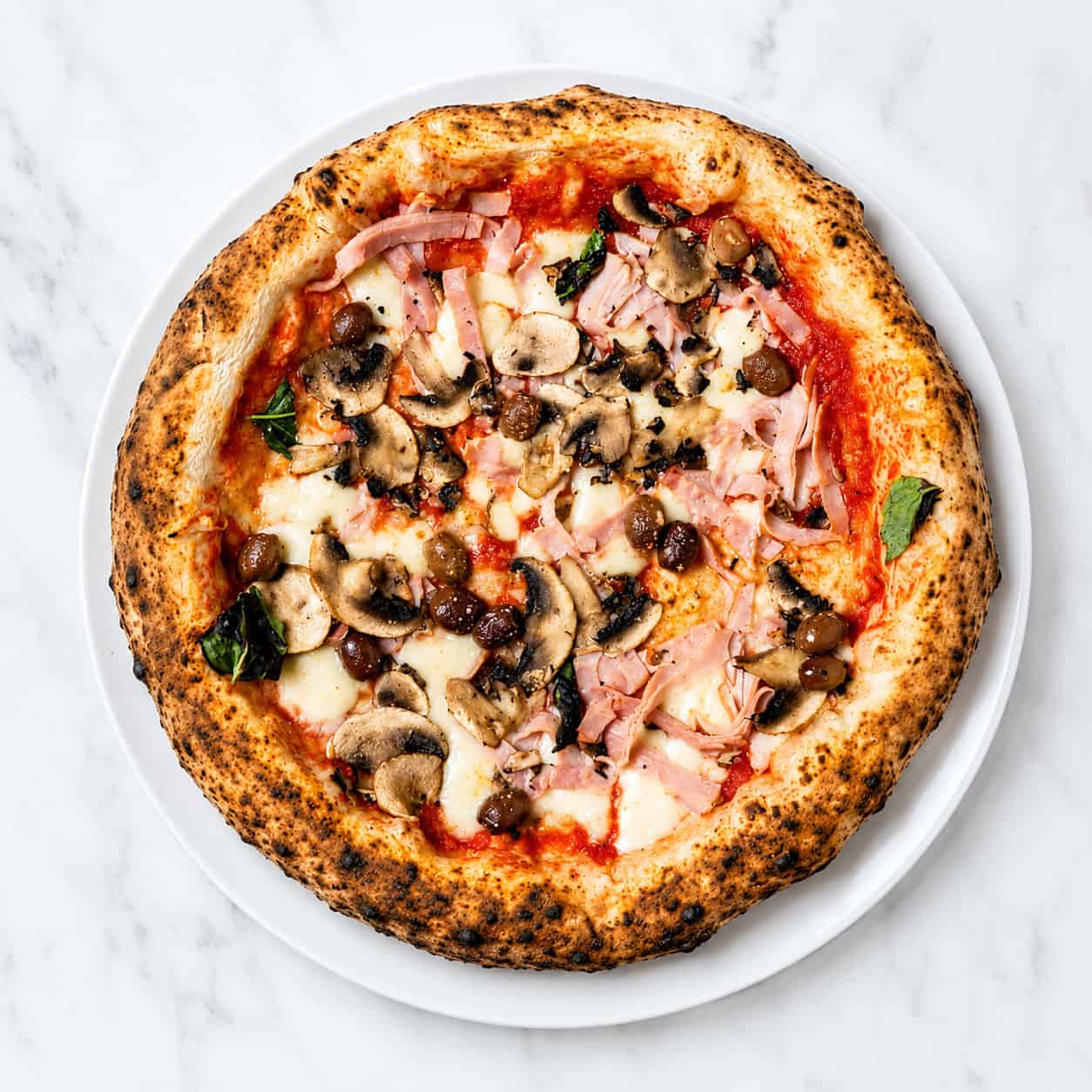 Capricciosa Pizza - Solania San Marzano, Fior di Latte, Double Smoked Shoulder Ham, Mushroom, Gaeta Black Olives, Basil, EVOO