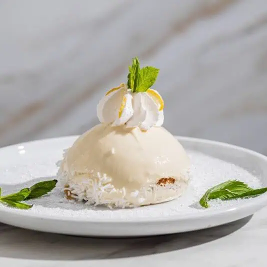 Traditional Italian Delizia al Limone dessert featuring sponge cake soaked in lemon syrup and filled with creamy lemon custard