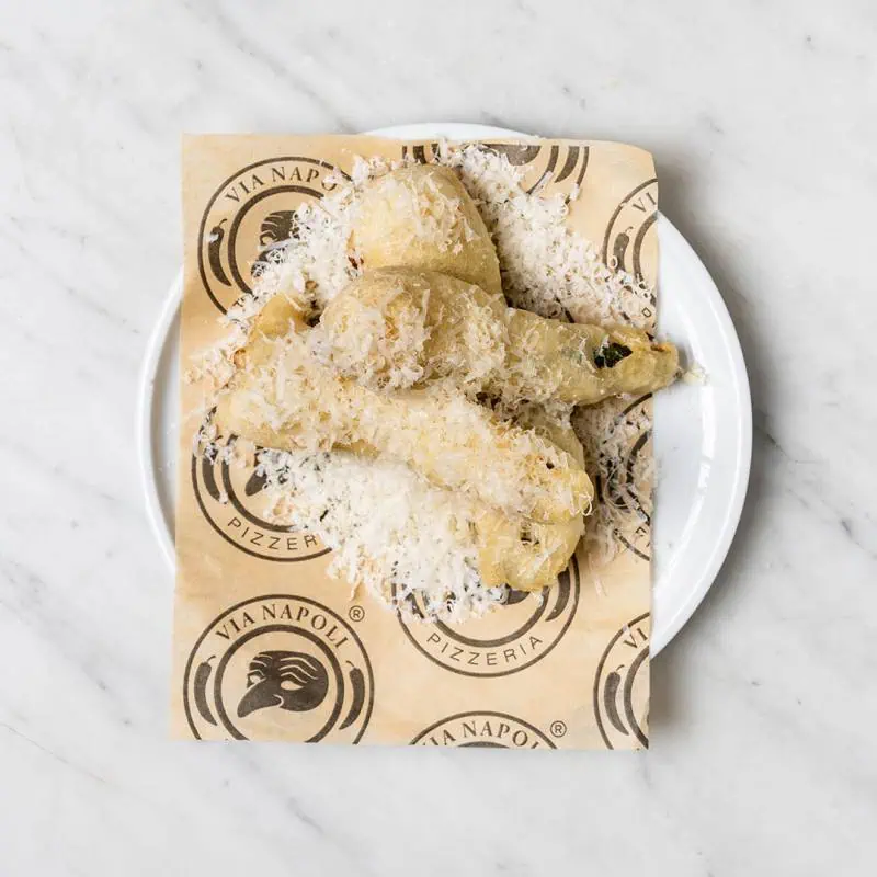 Stuffed zucchini flowers filled with buffalo ricotta and topped with Pecorino Romano cheese