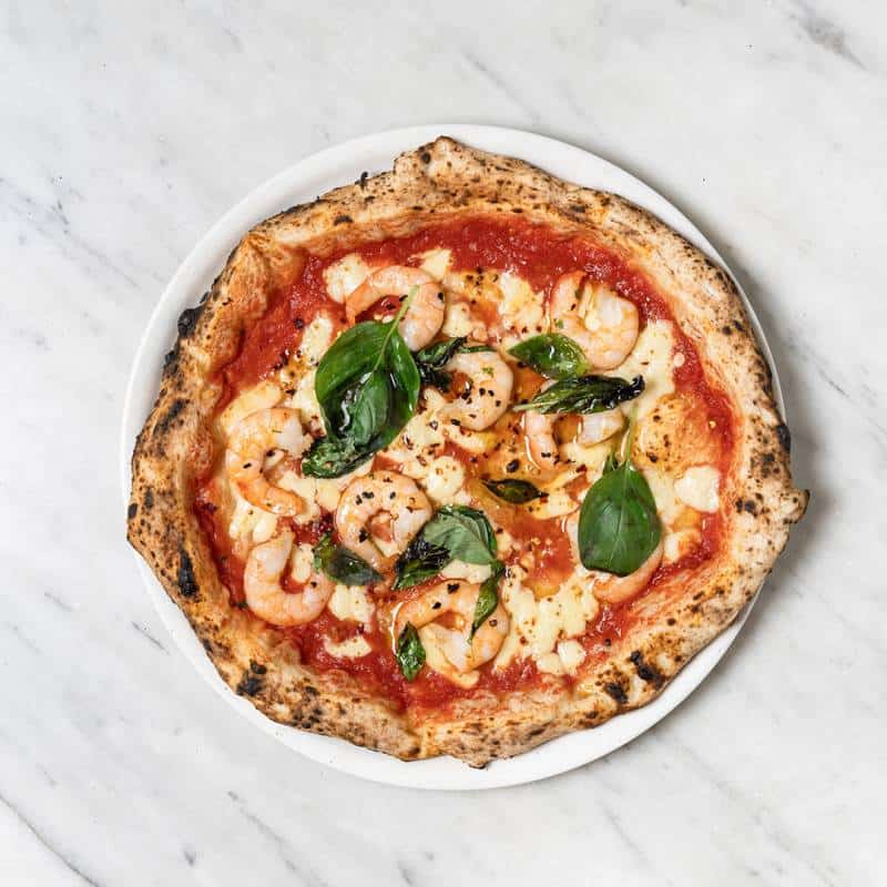 Gamberi pizza topped with fior di latte, San Marzano tomato, prawns, garlic, chilli, and fresh parsley