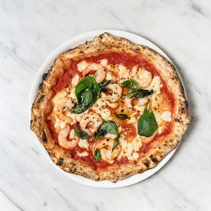 Gamberi pizza topped with fior di latte, San Marzano tomato, prawns, garlic, chilli, and fresh parsley