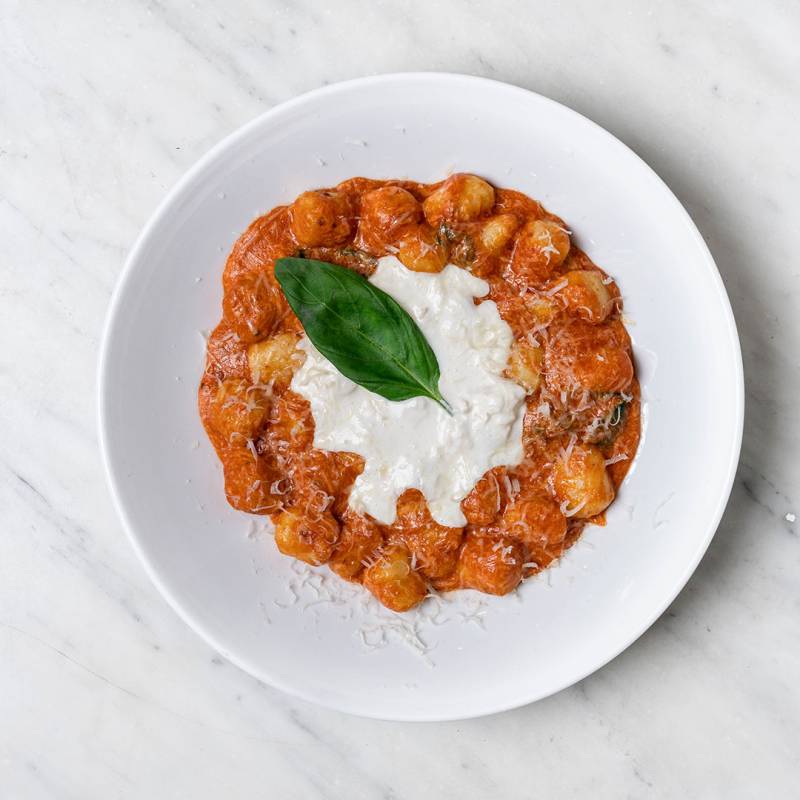 Homemade potato gnocchi baked in San Marzano tomato sauce with melted buffalo mozzarella, 36-month Parmigiano Reggiano, basil, and extra virgin olive oil