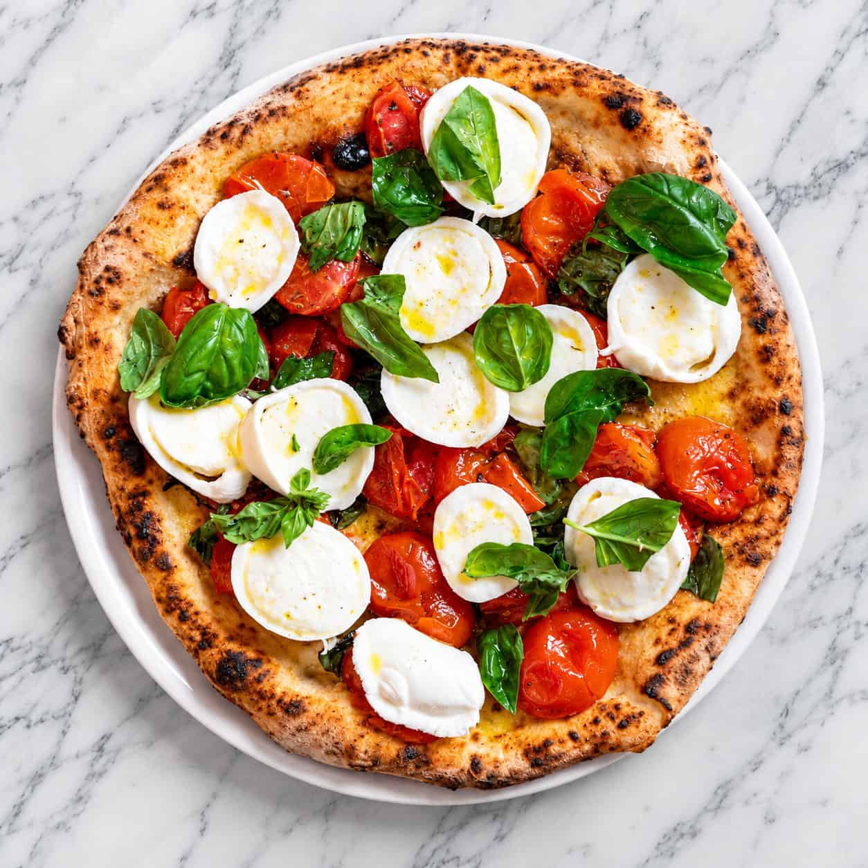 Illusione di Margherita Pizza - Pacchetelle Cherry Tomatoes, Buffalo Mozzarella, Pecorino Romano, Oregano, Basil, Levante EVOO from Andria