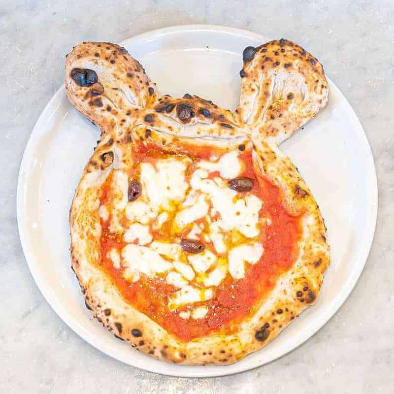 Mickey Mouse-shaped kids pizza with melted cheese and tomato base, available with salami, mushroom, or ham, served at Via Napoli
