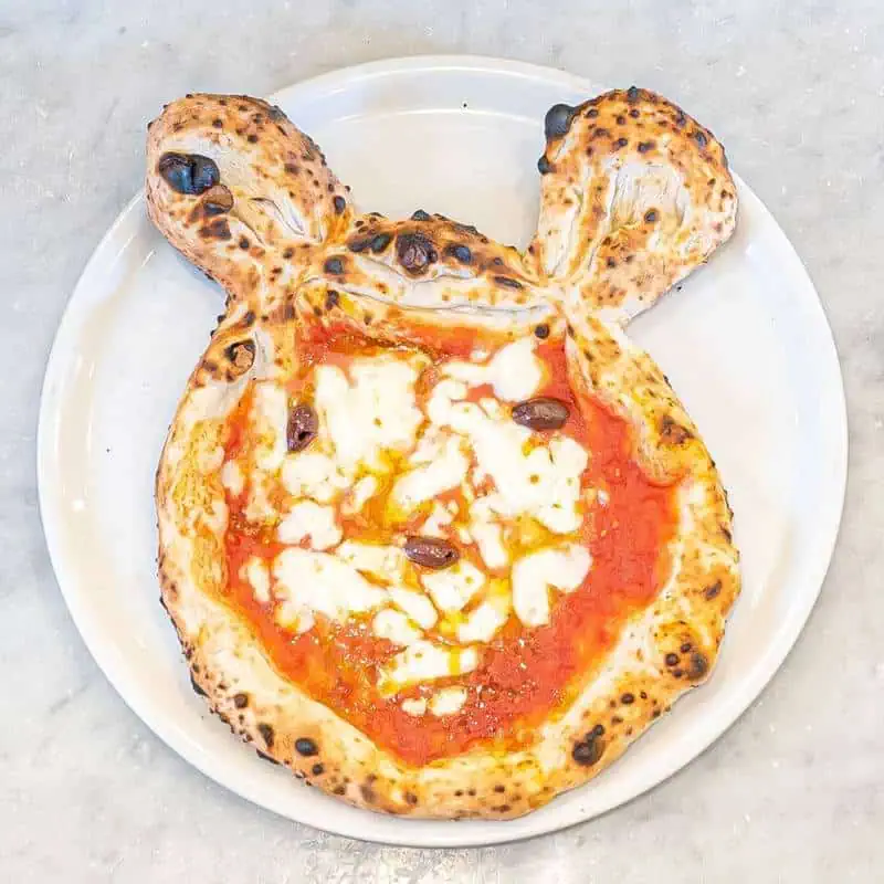 Fun Mickey Mouse-shaped kids' pizza with choice of toppings: cheese, ham, mushroom, olives, or salami