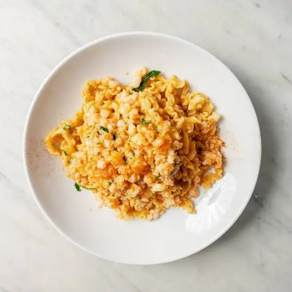 Homemade mafalde pasta served with prawns, garlic, chilli, rich prawn bisque, and fresh parsley