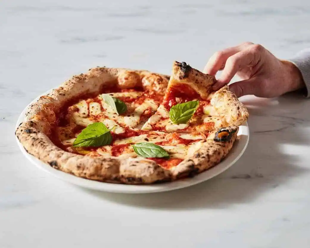 Margherita pizza slice lifted Neapolitan style Via Napoli