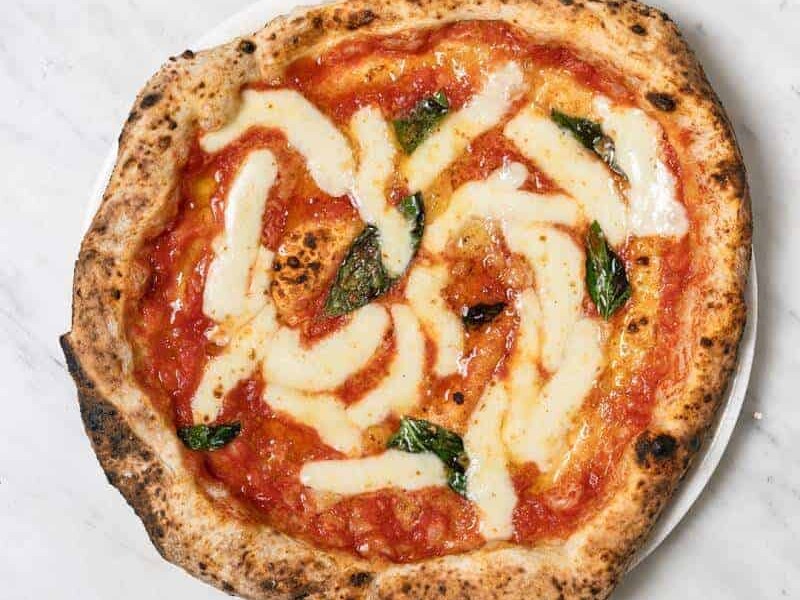 Margherita pizza topped with Solania San Marzano tomatoes, Fior di Latte, Pecorino Romano, Grana Padano DOP, fresh basil, and EVOO at Via Napoli