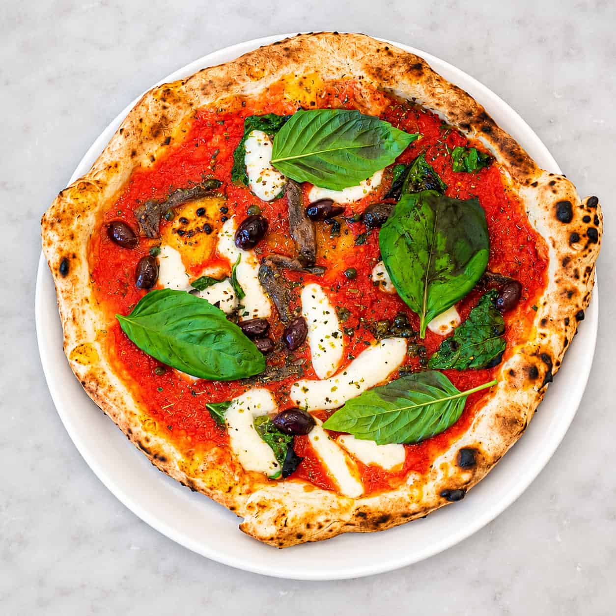 Napoletana Pizza - Solania San Marzano, Fior di Latte, Cetara Anchovies, Gaeta Black Olives, Capers, Oregano, Basil, EVOO