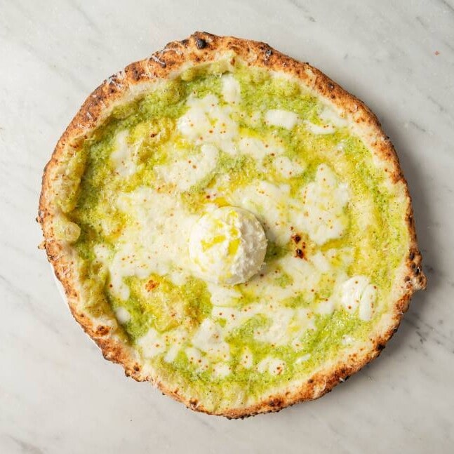 Nerano pizza topped with fior di latte, creamy zucchini purée, burrata cheese, shaved Parmesan, and fresh basil