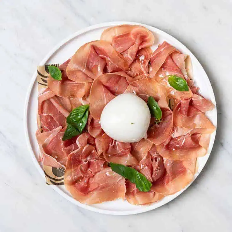 Thinly sliced Parma prosciutto served with creamy buffalo mozzarella at Via Napoli