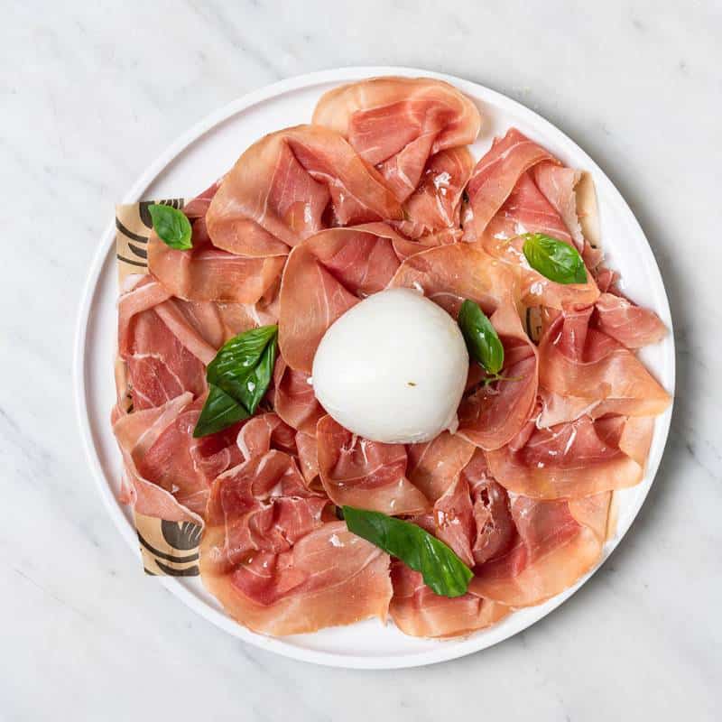 Puverella salad featuring 36-month aged Prosciutto di Parma, served with your choice of creamy burrata or buffalo mozzarella