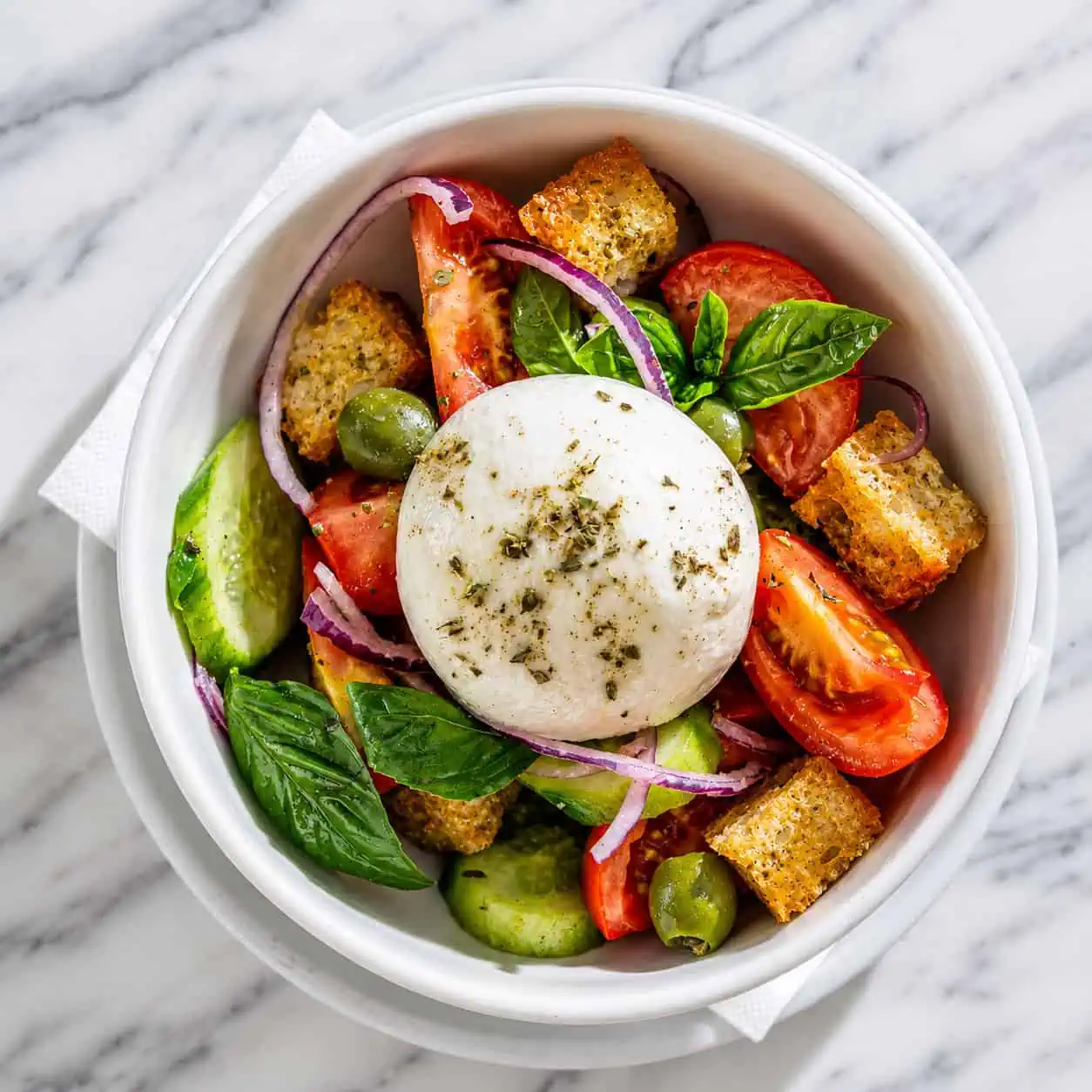 Puverella Salad - Vine-Ripened Tomatoes, Cucumber, Green Olives, Spanish Onions, Croutons, Burrata Cheese, EVOO, Oregano, Basil
