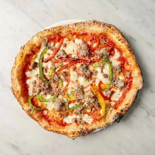 Salsiccia pizza topped with Italian pork sausage, fior di latte, San Marzano tomato, scamorza, chilli, roasted capsicum, Parmesan, and fresh basil