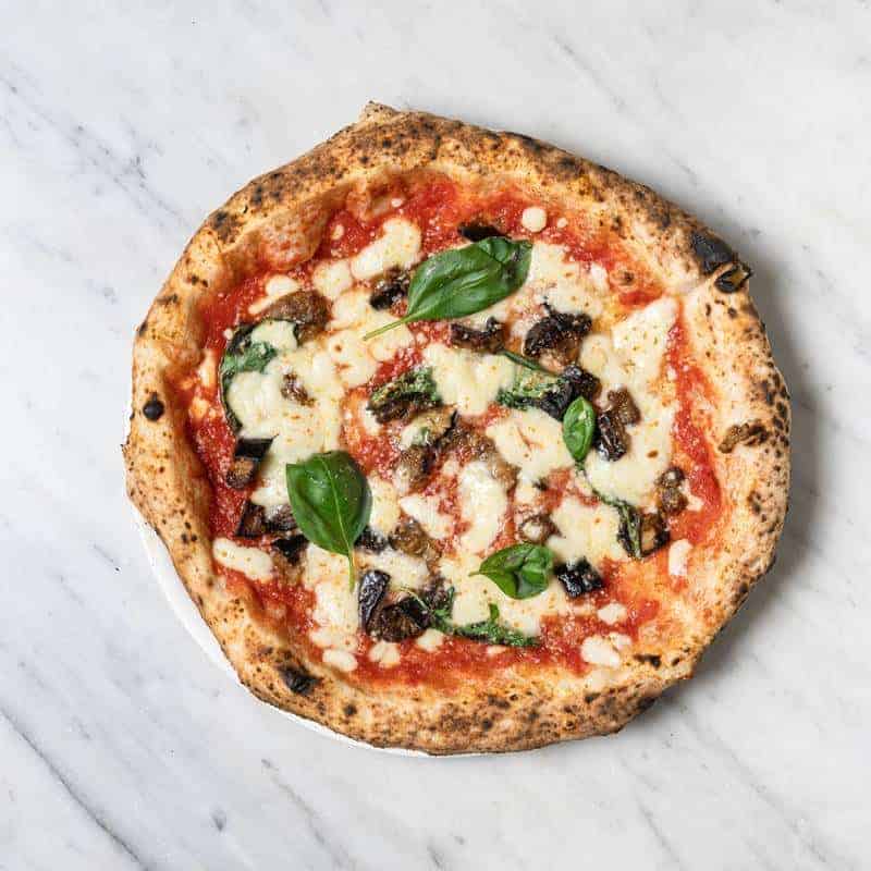 Siciliana pizza topped with Solania San Marzano tomatoes, Fior di Latte, roasted eggplant, Grana Padano DOP, fresh basil, and EVOO at Via Napoli