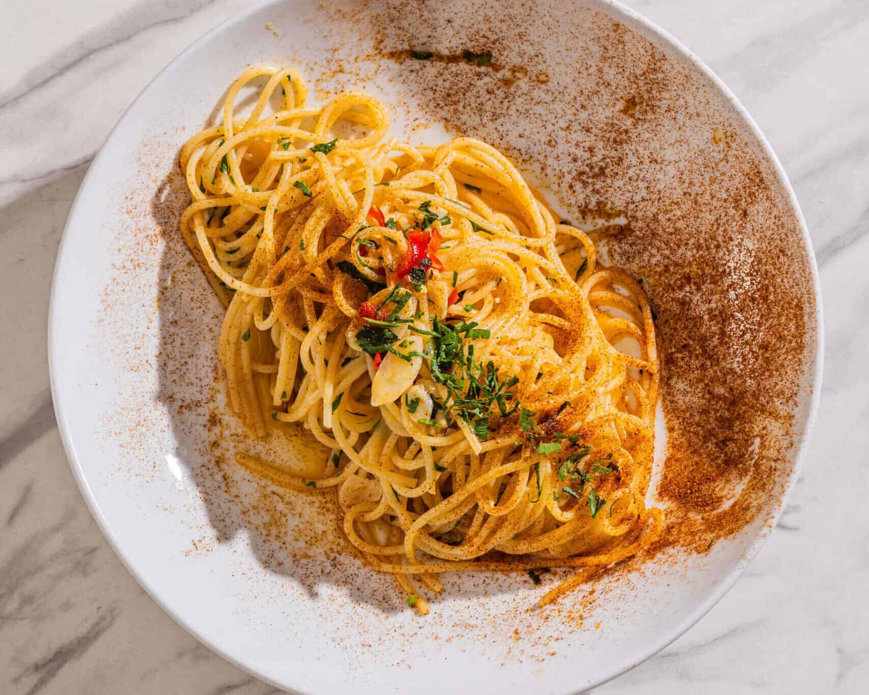 Spaghetti Aglio, Olio e Peperoncino — a simple Italian pasta dish tossed with chilli, garlic, and extra virgin olive oil, garnished with parsley