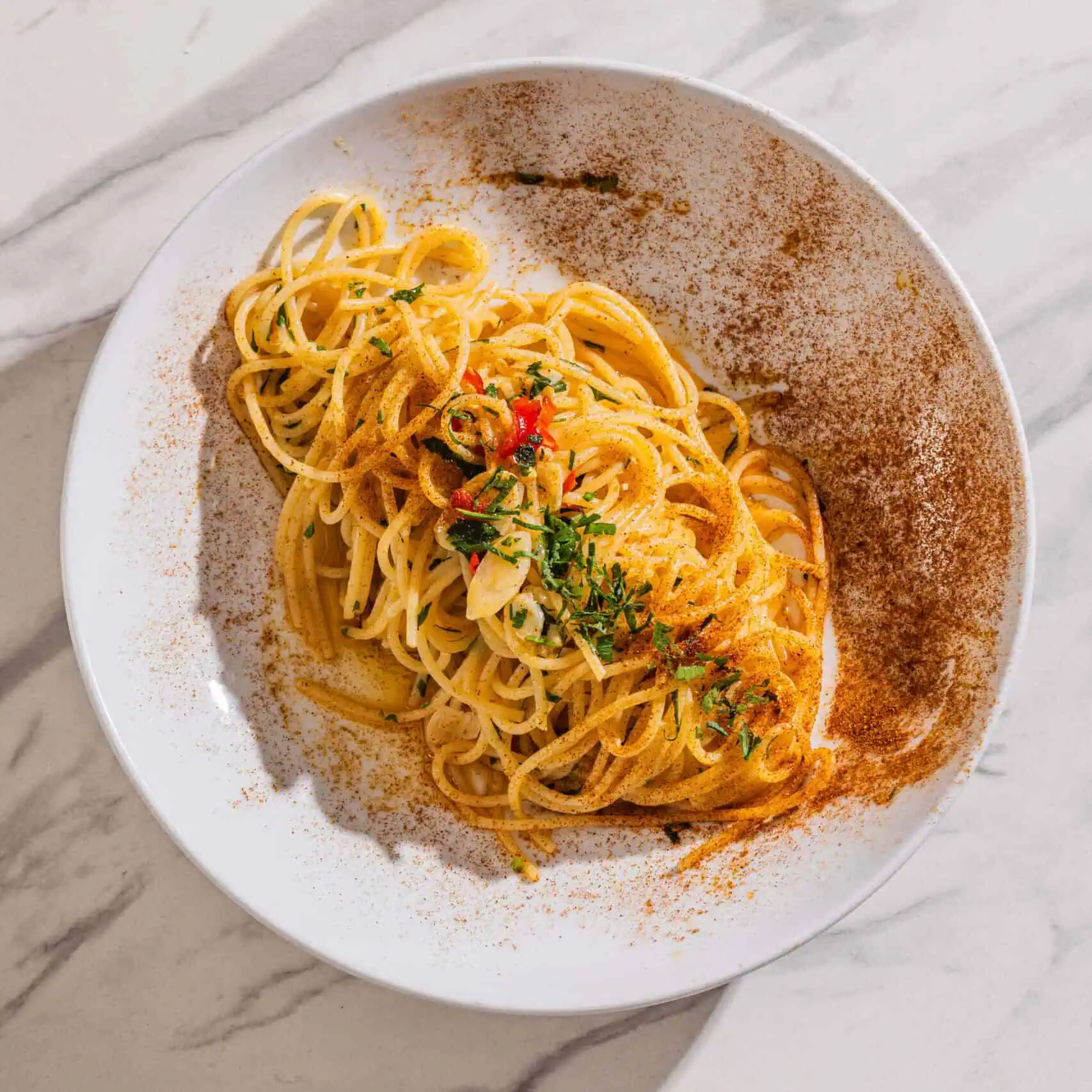 Spaghetti Aglio, Olio e Peperoncino — a simple Italian pasta dish tossed with chilli, garlic, and extra virgin olive oil, garnished with parsley