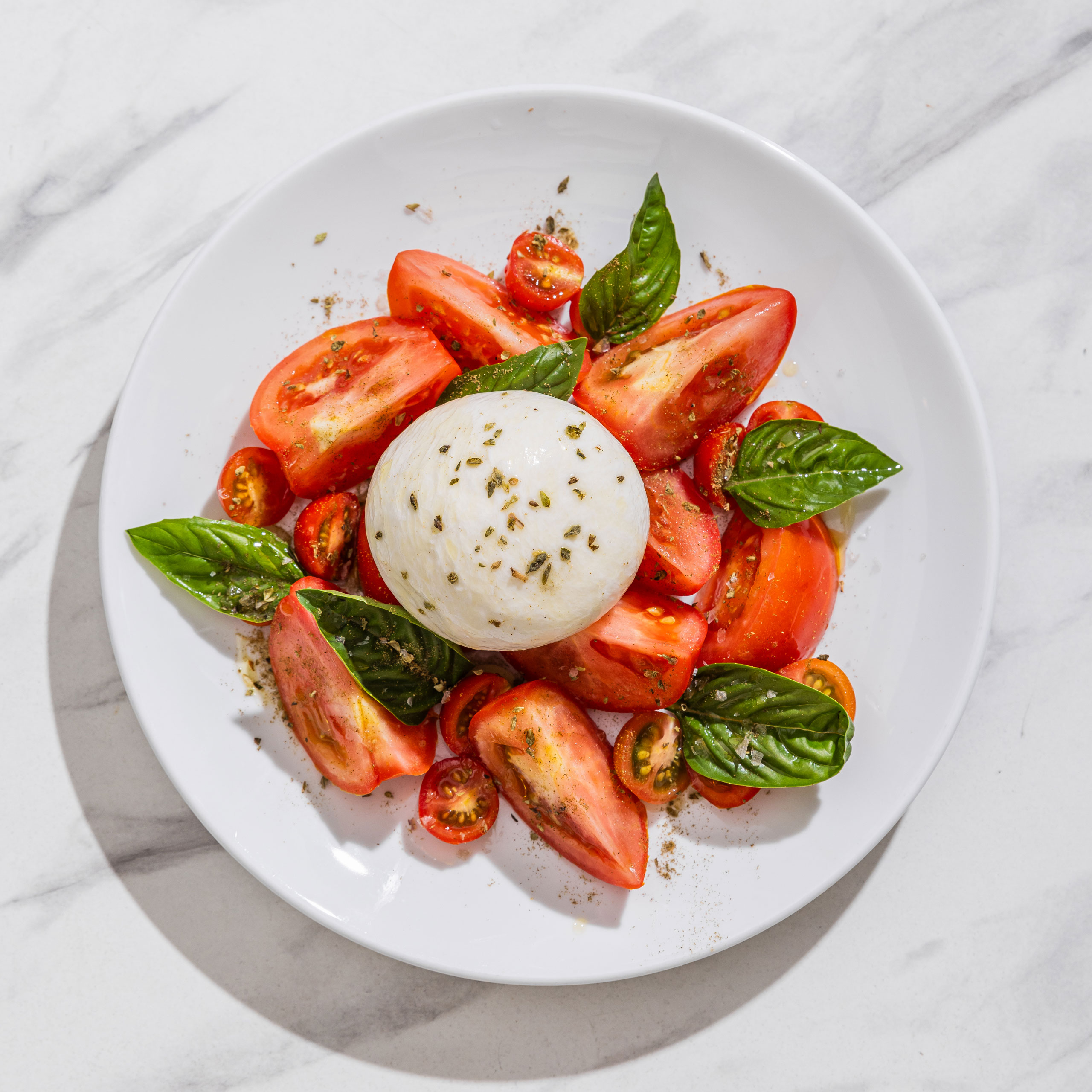Tomato salad with fresh mozzarella, basil leaves, and tomatoes from Via Napoli Pizzeria