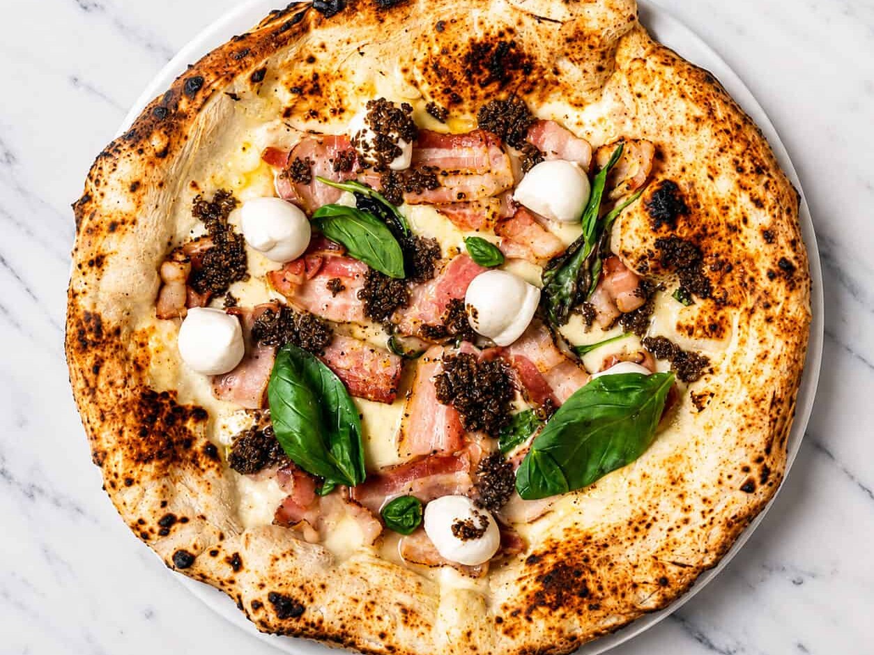 Truffle Pizza - White Base, Buffalo Mozzarella, Pancetta, Black Truffle, Buffalo Bocconcini, Basil, EVOO