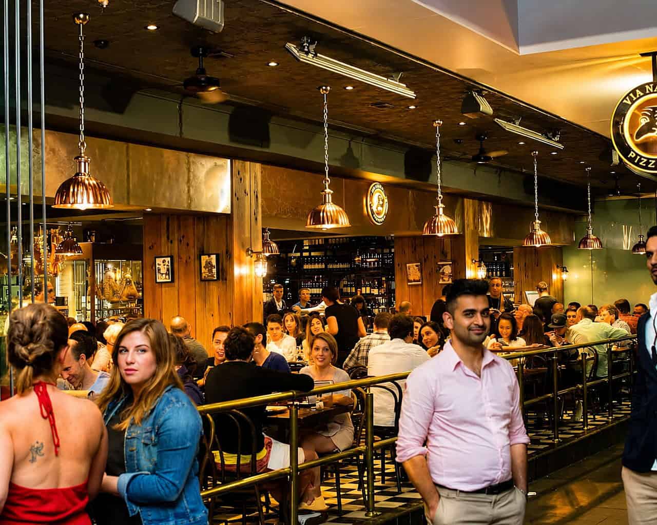 Interior view of Via Napoli Pizzeria in Surry Hills with diners enjoying Italian cuisine in a lively atmosphere.
