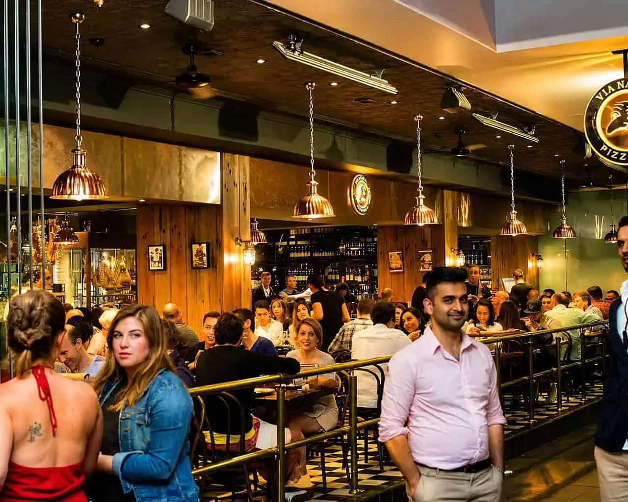 Interior view of Via Napoli Pizzeria in Surry Hills with diners enjoying Italian cuisine in a lively atmosphere.