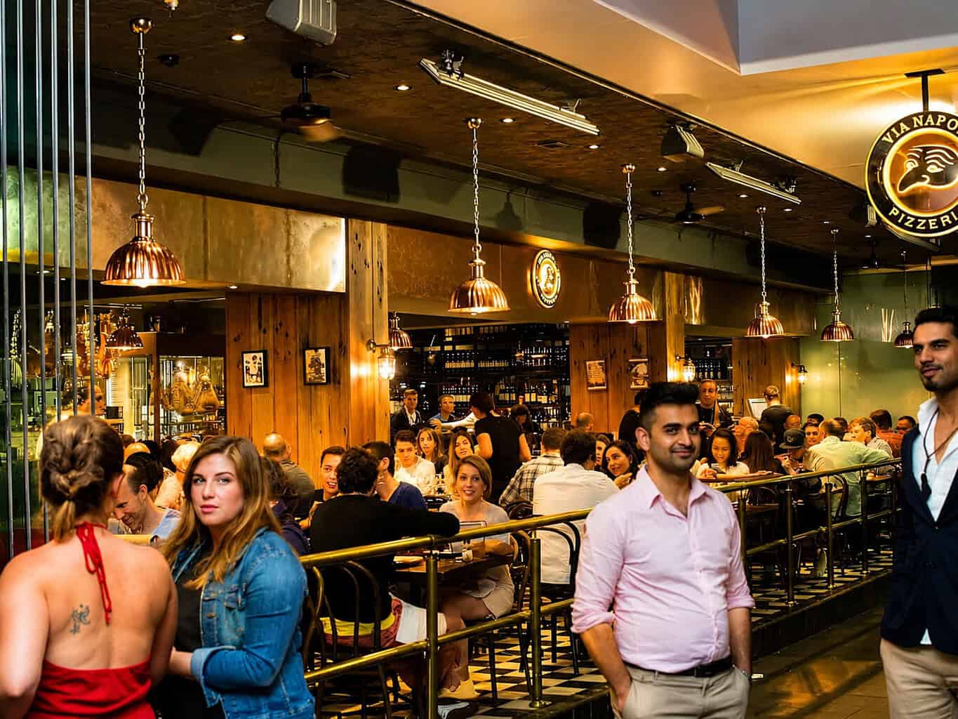 Interior view of Via Napoli Pizzeria in Surry Hills with diners enjoying Italian cuisine in a lively atmosphere.