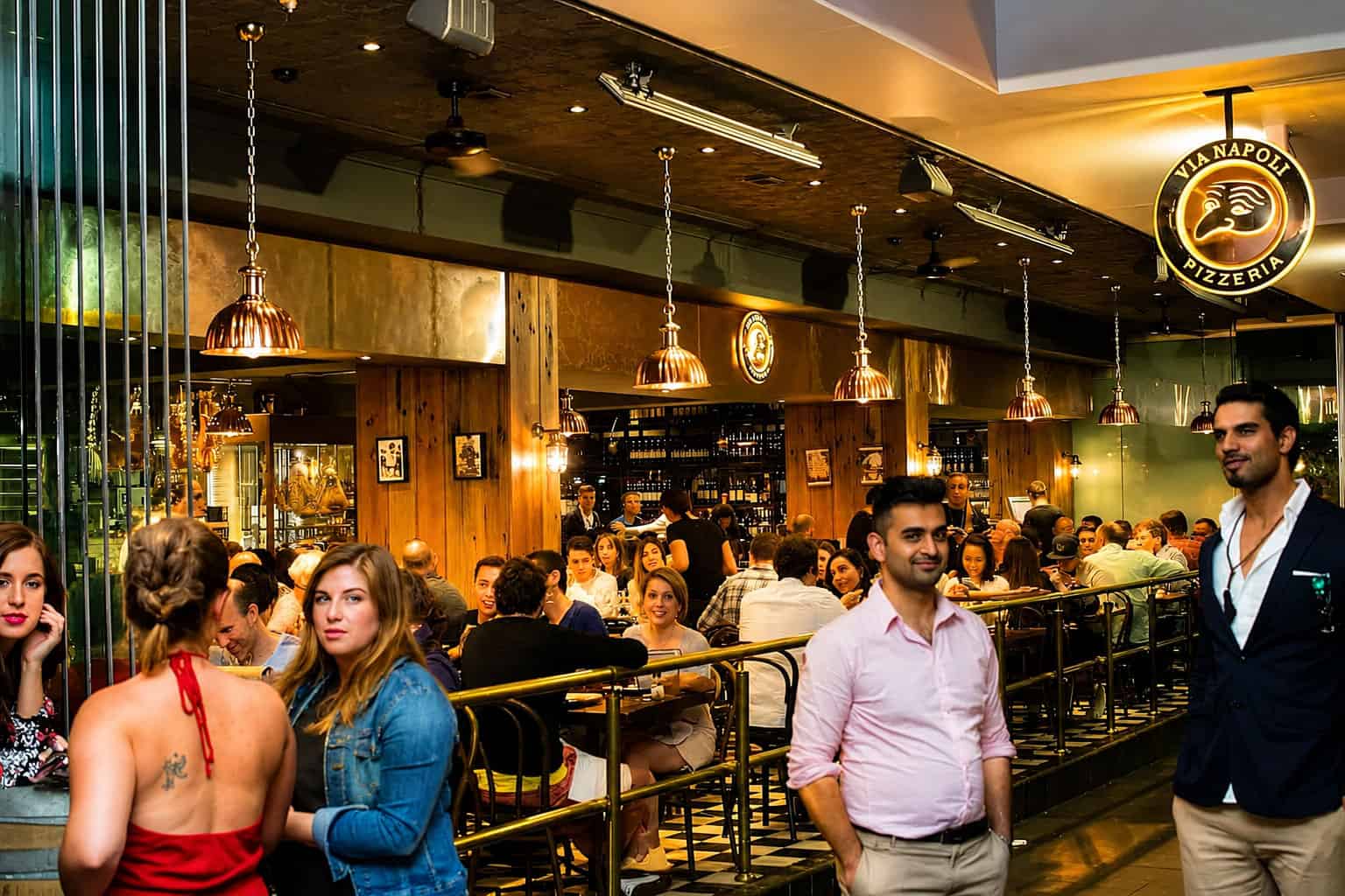 Interior view of Via Napoli Pizzeria in Surry Hills with diners enjoying Italian cuisine in a lively atmosphere.