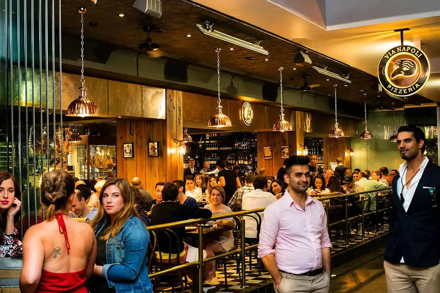 Interior view of Via Napoli Pizzeria in Surry Hills with diners enjoying Italian cuisine in a lively atmosphere.